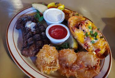 Rusty's Ranch House signature dishes Steak and BBQ Ribs
Ranch House Ribeye
Rusty's Sampler Platter